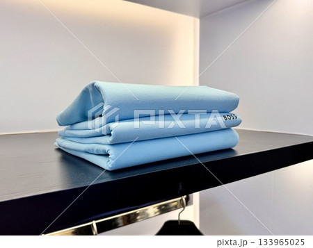 stylish luxury men's clothing store, new cotton T-shirts are on the store shelf stylish luxury men's clothing store, new cotton T-shirts are on the store shelf 133965025