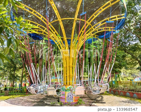 Colorful Chair Swing Carousel Ride in an Outdoor Park Colorful Chair Swing Carousel Ride in an Outdoor Park 133968547