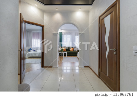 Bright Hallway with Arched Entrance and View into Cozy Living and Bedroom Areas Bright Hallway with Arched Entrance and View into Cozy Living and Bedroom Areas 133968761