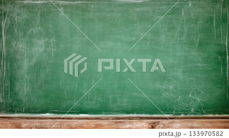 Close-up of a dirty green chalkboard with chalk dust and scratches. A wooden shelf sits at the bottom. Ideal as a background for educational themes, school concepts, or menu boards. 133970582