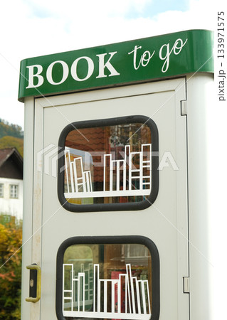 Book to go. Public street book-sharing kiosk with free community books for readers Book to go. Public street book-sharing kiosk with free community books for readers 133971575