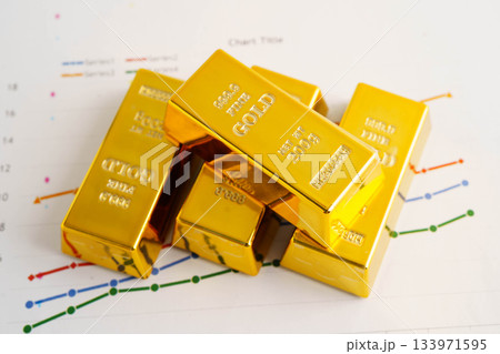 Gold bars on graph paper, finance trading investment business currency. 133971595
