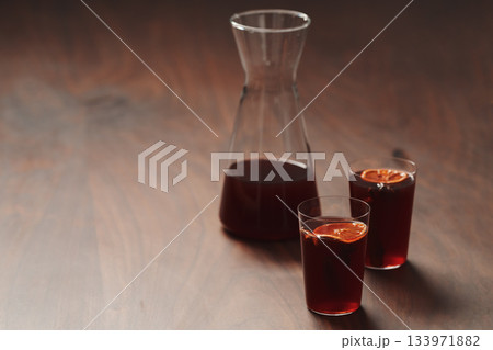 Mulled wine in tumbler glasses on walnut table with copy space Mulled wine in tumbler glasses on walnut table with copy space 133971882