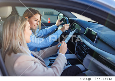 Driving Examiner Reviewing Tasks with Student During Road Test 133973548
