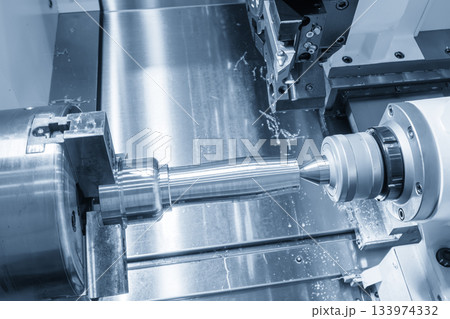 The operation CNC lathe machine finish cut the metal shaft parts in the light blue scene. 133974332