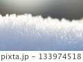 Macro shot of icy frost crystals on snow in soft morning light Macro shot of icy frost crystals on snow in soft morning light 133974518