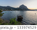 Sunrise over the bay of Novy Svet with a view of the mountain and boats on the water Sunrise over the bay of Novy Svet with a view of the mountain and boats on the water 133974529