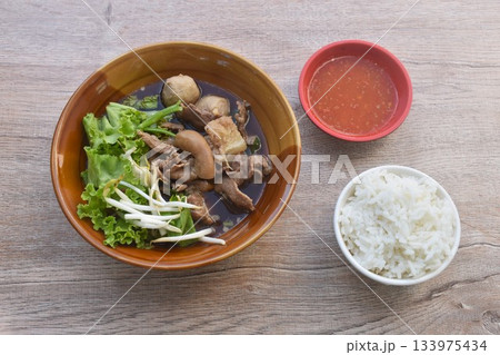 boiled braised beef meat and tendon couple organ in herb brown soup on bowl dipping spicy chili sauce eat couple with plain rice 133975434