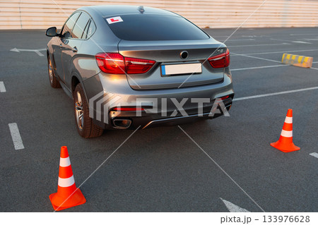 Driving School Car Positioned Between Cones on Practice Parking Area 133976628