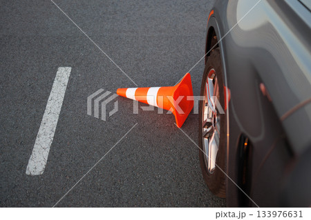 Traffic Cone Knocked Down Beside Car Wheel During Driving Lessons 133976631