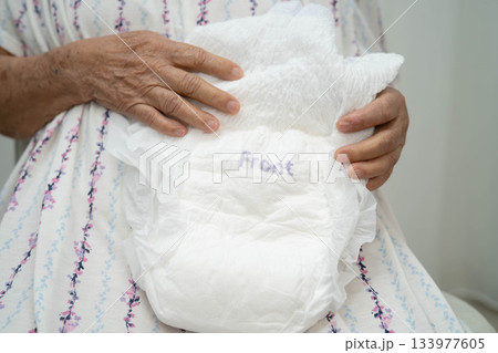 Asian senior woman patient wearing adult incontinence diaper pad in hospital. Asian senior woman patient wearing adult incontinence diaper pad in hospital. 133977605