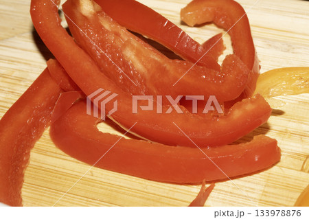 Close up of chopped sliced sweet pepper on a wooden chopping board 133978876