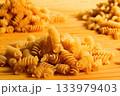 Texture of dry fusilli pasta. Italian cuisine 133979403