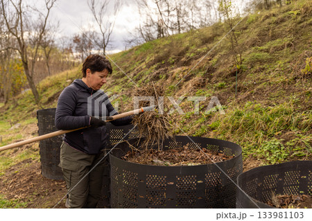 Woman composting organic waste 133981103