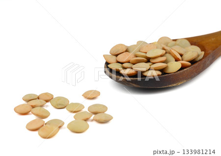 Pile lentil in wooden spoon isolated on White background. Top view. 133981214