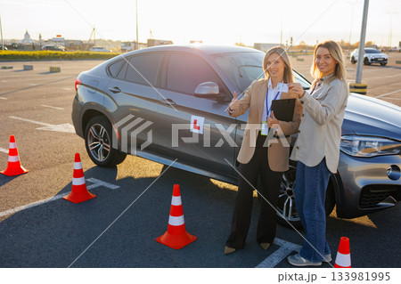 Learner Driver and Instructor Showing Passed Driving License at Test Area 133981995