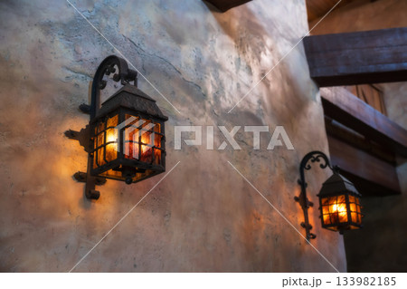 Vintage lamp light up attached on castle wall 133982185
