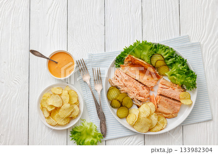hot smoked trout fillet with lettuce, potato chips 133982304