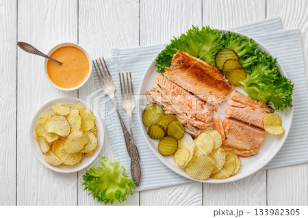 hot smoked trout fillet with lettuce, potato chips hot smoked trout fillet with lettuce, potato chips 133982305