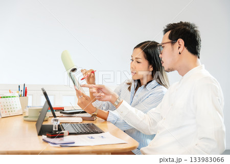 Businessman and woman having a meeting at work desk on laptop computer at home in relaxed pose Working, Business communication online, Planning, Analysis Businessman and woman having a meeting at work desk on laptop computer at home in relaxed pose Working, Business communication online, Planning, Analysis 133983066