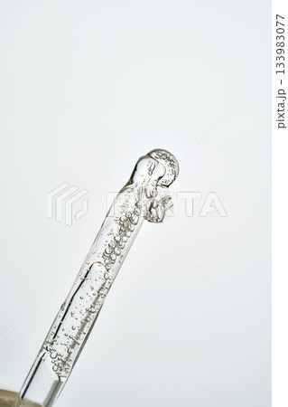Cosmetic pipette filling with clear serum and bubbles Cosmetic pipette filling with clear serum and bubbles 133983077
