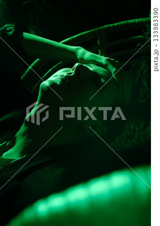 reclining figure in green light, dancer resting backstage reclining figure in green light, dancer resting backstage 133983390