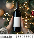 Christmas Red Wine Bottle Label Mockup with Festive Tree Lights 133983605