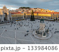 The scenic Praca do Comercio in Lisbon showcases a Christmas tree against the sunset sky, highlighting festive winter charm in the evening. Lisbon, Portugal 133984086