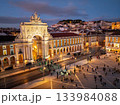 Experience the magic of Christmas in Lisbon as Praca do Comercio glows with festive lights in the evening twilight. 133984088