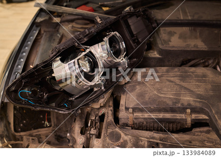 Careful precision is essential when installing a car headlight assembly for optimal performance 133984089