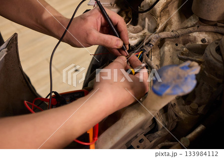 Careful precision is essential when installing a car headlight assembly for optimal performance 133984112