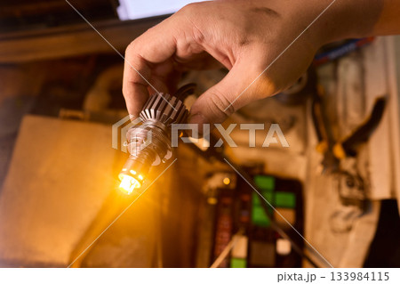 Careful precision is essential when installing a car headlight assembly for optimal performance 133984115