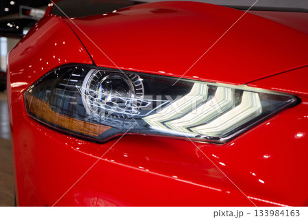 Close up of a cars headlight, part of automotive design Close up of a cars headlight, part of automotive design 133984163