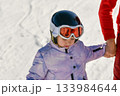 Ski coach giving a lesson to a child 133984644