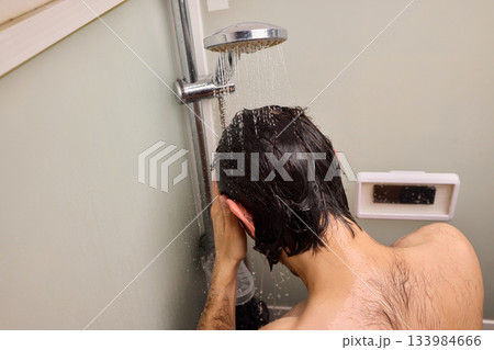 Personal hygiene routine, Cleaning and relaxing shower time, Individual cleansing session in steamy bathroom, Relaxing personal grooming amidst humid shower environment 133984666