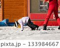 The girl fell while learning to ski.Ski coach giving a lesson to a child 133984667