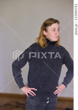 Woman exercises indoors, Individual with cerebral palsy performing warmup, Serene young woman with mobility challenges practicing controlled physiotherapy routines indoors 133984781