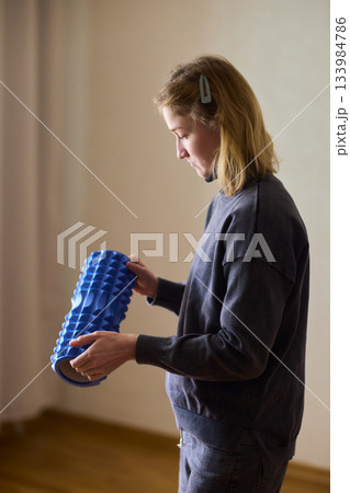 Woman exercises indoors, Individual with cerebral palsy performing warmup, Serene young woman with mobility challenges practicing controlled physiotherapy routines indoors 133984786