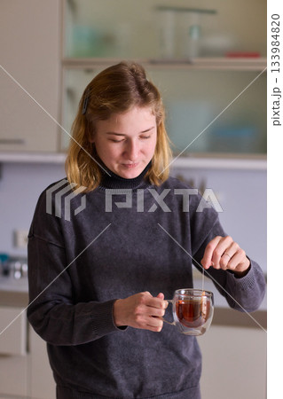 Cerebral palsy Morning tea moment, Relaxed individual enjoying peaceful routine with hot beverage, Tranquil domestic scene highlighting personal care during quiet morning moment 133984820