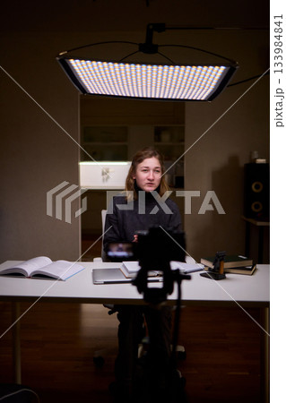 Young lady with cerebral palsy studying using technological aids, Enthusiastic woman with cerebral palsy learning with aid of modern assistive technology at bright workspace 133984841