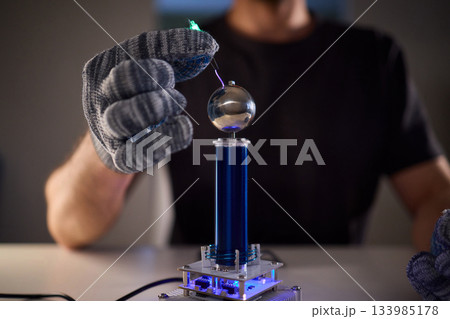 Expert carefully calibrates plasma equipment using sensitive techniques, Research professional employs meticulous methods to adjust plasma probe with expert precision Expert carefully calibrates plasma equipment using sensitive techniques, Research professional employs meticulous methods to adjust plasma probe with expert precision 133985178
