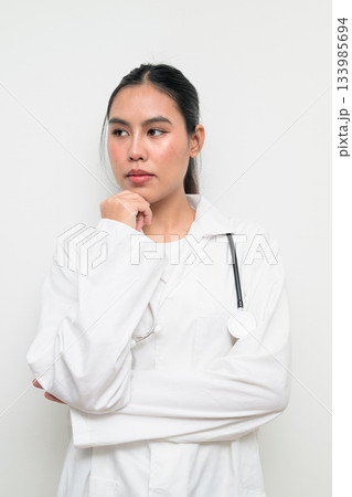 Woman Doctor with Stethoscope in White Uniform on Plain Background Thinking Woman Doctor with Stethoscope in White Uniform on Plain Background Thinking 133985694