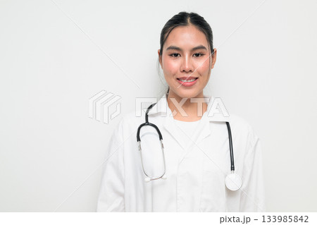 Happy Woman Doctor with Stethoscope in White Uniform on Plain Background Smiling 133985842