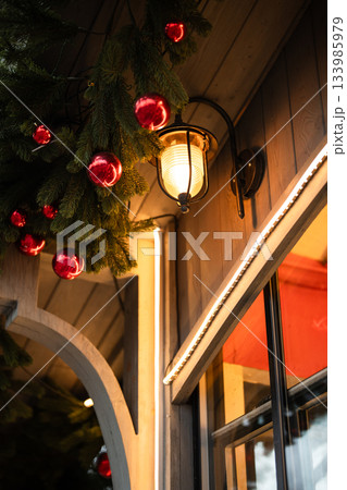 Cozy winter decorations made from fir branches, red glass balls as Christmas decorations for cafe Cozy winter decorations made from fir branches, red glass balls as Christmas decorations for cafe 133985979