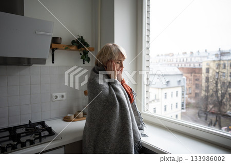 Middle aged woman suffering from seasonal weather changes, having headache and high temperature. 133986002