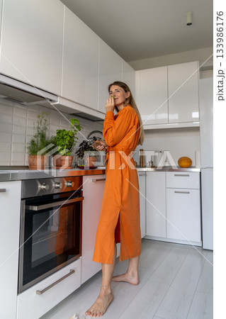 Pleased woman inhale freshly cut foliage scent of basil, evaluate herb health for kitchen ingredient Pleased woman inhale freshly cut foliage scent of basil, evaluate herb health for kitchen ingredient 133986176