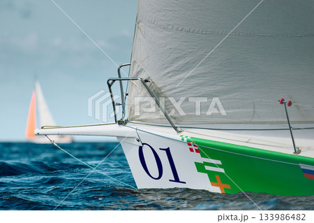 bow of a sailing boat with bowsprit at sailing regatta in the Gulf of Finland at sunny day, sailing yacht competing in a race, splashing water from under the boat, teamwork, board the boat bow of a sailing boat with bowsprit at sailing regatta in the Gulf of Finland at sunny day, sailing yacht competing in a race, splashing water from under the boat, teamwork, board the boat 133986482