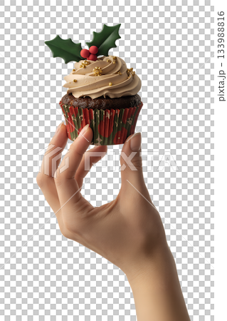 Single holiday cupcake with classic holly decoration held in hand, perfect for seasonal baking, cafe menus, or gift ideas 133988816