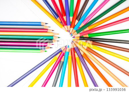 A vibrant arrangement of colored pencils in a circular pattern with some pencils  133991036