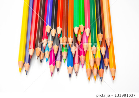 A vibrant row of sharpened colored pencils in various hues, arranged in a wave-like pattern against A vibrant row of sharpened colored pencils in various hues, arranged in a wave-like pattern against 133991037